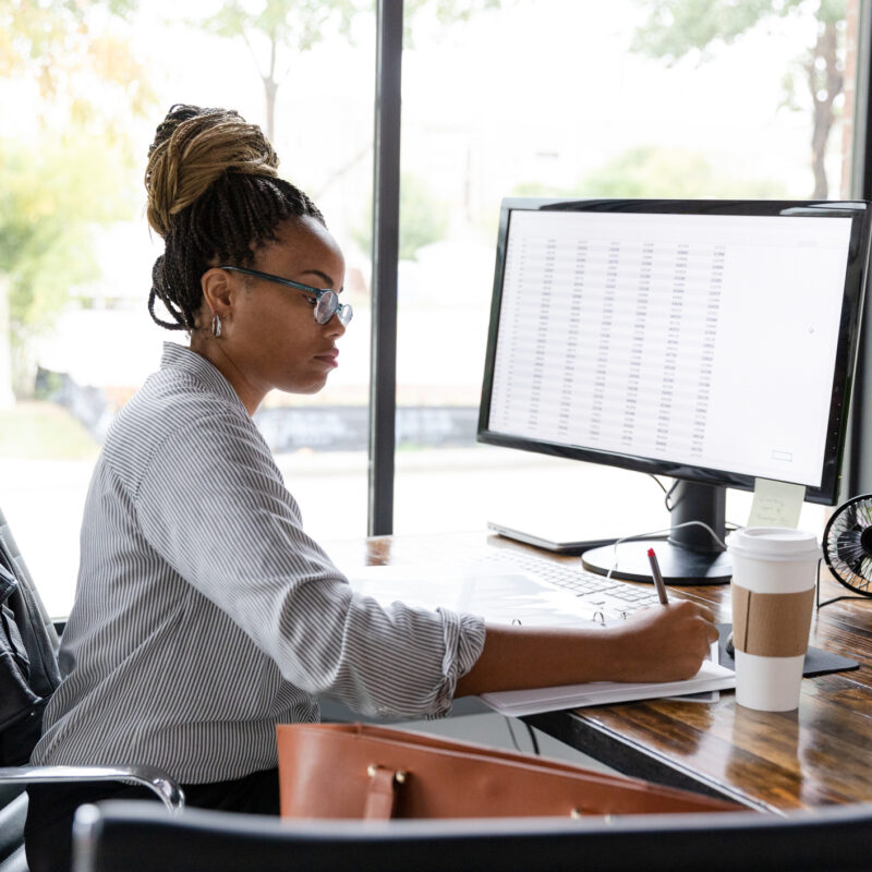 woman at computer working, health plan MRF data