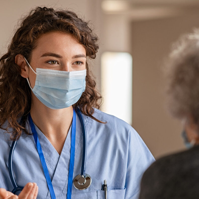 Healthcare provider discussing healthcare price transparency mandates with elderly female