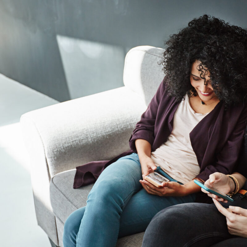 two women on couch comparing healthcare providers