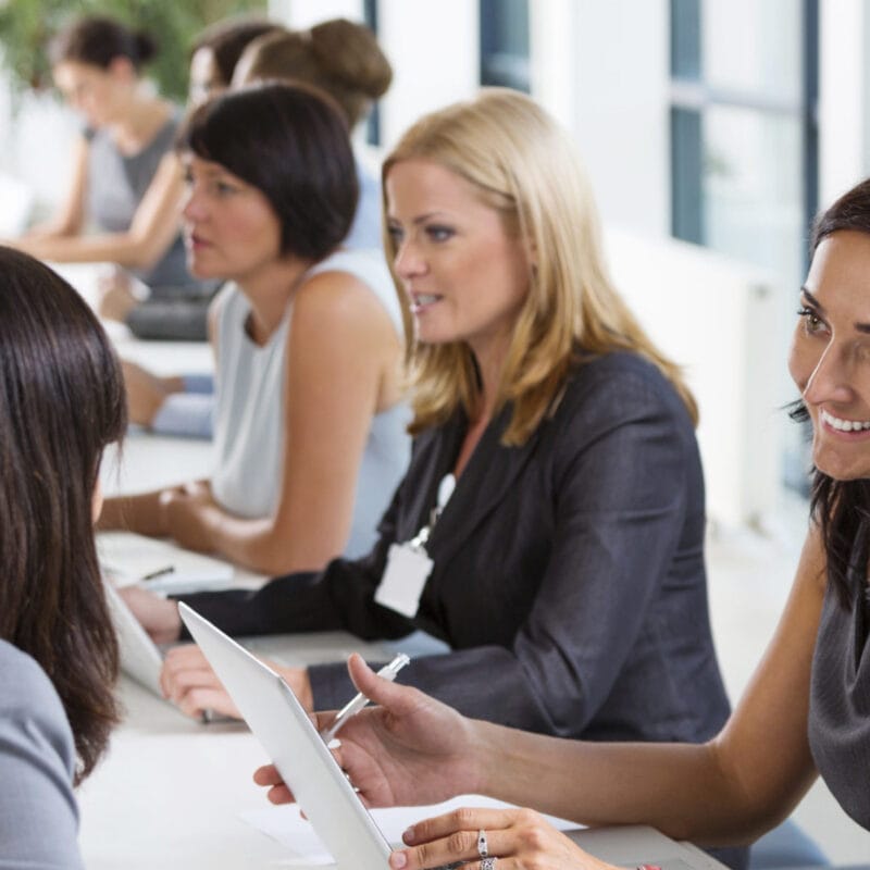 group of women chatting around table