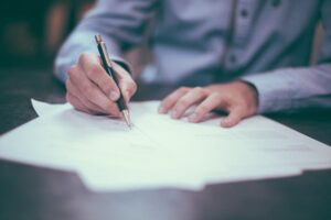 hands filling out documents