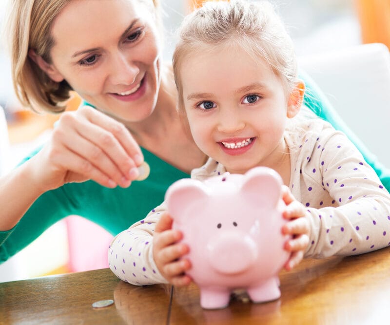 mother and child using piggy bank to save for financial incentives