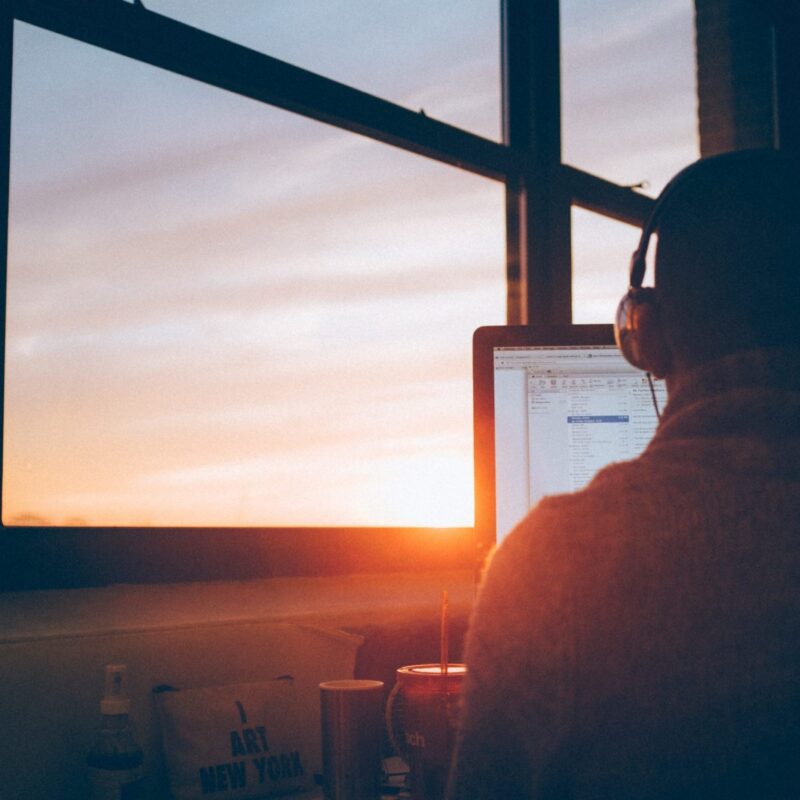 man in headphones working on computer reading price transparency mandate